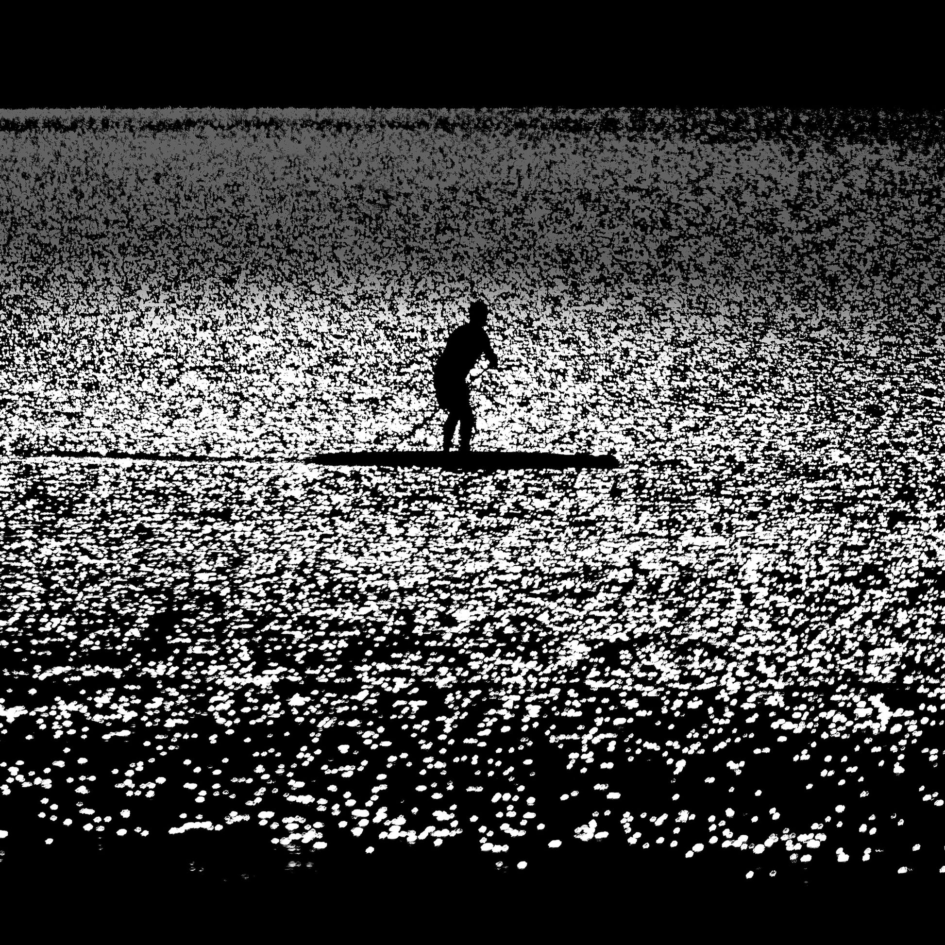 Nami no Tabibito — paddleboarder silhouette on a vast glittering silver sea, black and white fine art photography